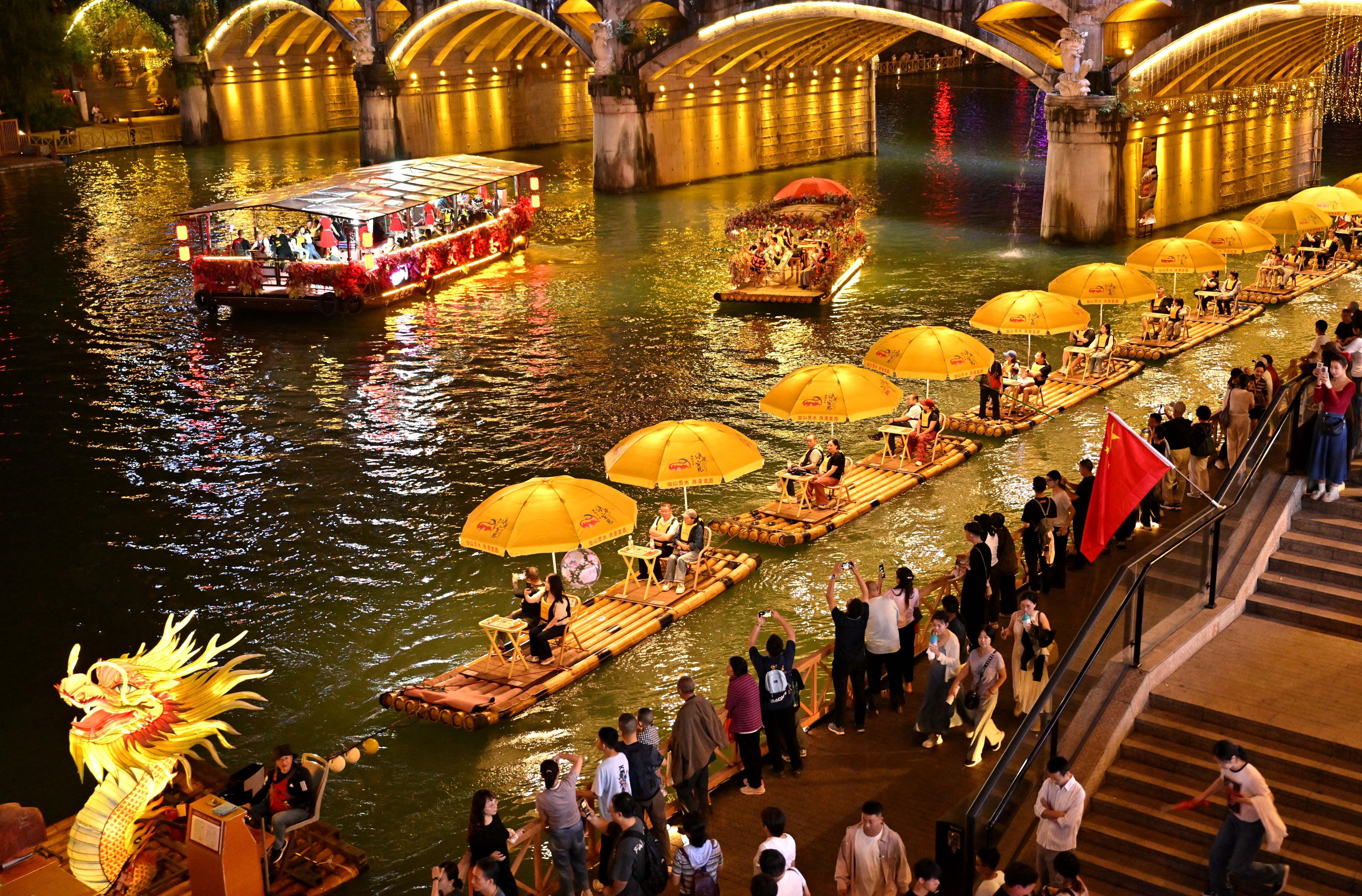 Tourists take bamboo rafts at a scenic area in Xuan en County, Enshi Tujia and Miao Autonomous Prefecture, central China s Hubei Province, Oct. 3, 2025. (Photo by Song Wen/Xinhua)